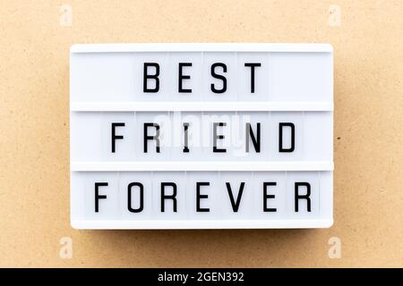 Light box with word best friend forever on wood background Stock Photo