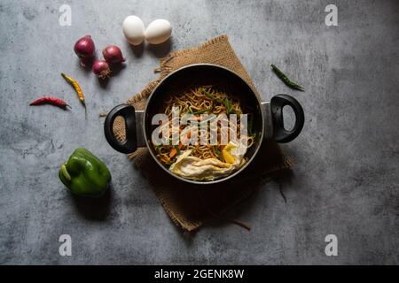 Pan fried noodles prepared with chopped vegetables and udon noodles. Stock Photo