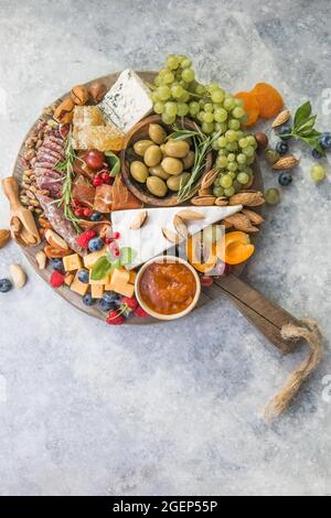 Charcuterie board. Cheese platter. Assortment of tasty appetizers or antipasti. Top view. Copy space. Stock Photo