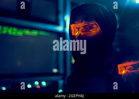 Cyber hacker breaks into databases to obtain information using a computer. Cybercrime and data security concept. Stock Photo