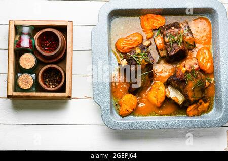 Beef ribs stewed in apricots. Veal meat with fruit sauce Stock Photo