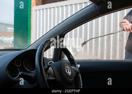 Cleaning a car in a hand car wash in the UK Stock Photo