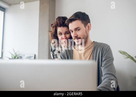 Two astonished office workers reading an email message Stock Photo