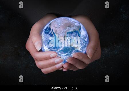 Female hands holding Earth in outer space, concept save the world and nature. Stock Photo