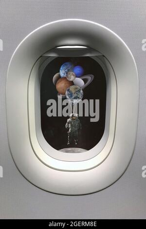 View from porthole window on astronaut with planets shaped balloons in solar system. Elements of this image furnished by NASA. Stock Photo