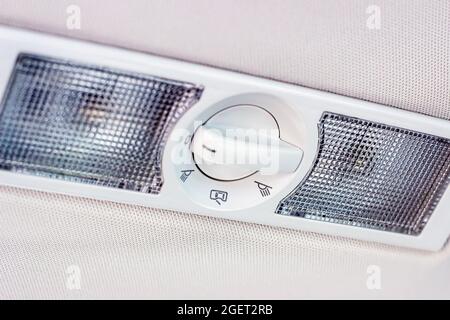 Lamp light control panel inside the car in the automobile ceiling for passengers. Stock Photo