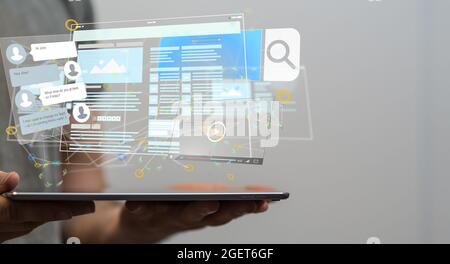 Male's hands holding an illustration of virtual develop interface web application in hand Stock Photo