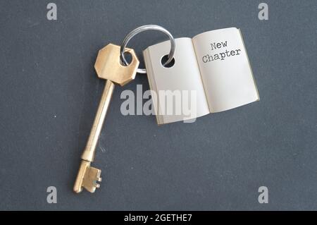 Keyring with open book and chapter one on a chalkboard Stock Photo