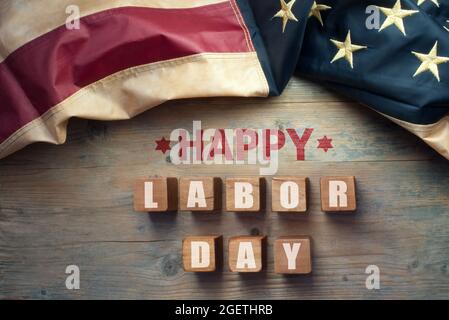 Happy labor day printed on wooden blocks with vintage American flag Stock Photo