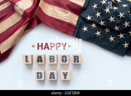 Happy labor day printed on wooden blocks with vintage American flag Stock Photo