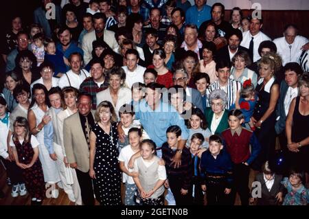 Glen Campbell (bottom center blue shirt) and friends and relatives gather for a photo during his surprise 60th birthday celebration on April 21, 1996 in Branson, Missouri. Glen Campbell's actual birth date was April 22, 1936. He died of complications from Alzheimer's disease on August 8, 2017. Stock Photo