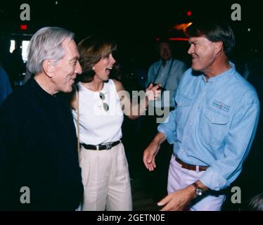 A very excited Debbie Williams, wife of Andy Williams at left, greets Glen Campbell at his surprise 60th birthday celebration on April 21, 1996 in Branson, Missouri. Glen Campbell's actual birth date was April 22, 1936 Stock Photo
