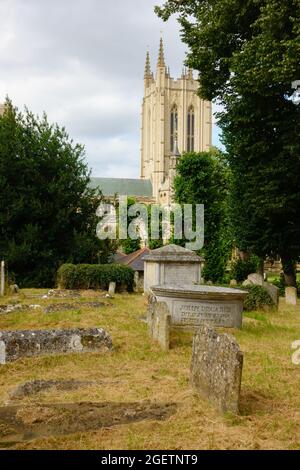 St Edmundsbury Cathedral from St Mary's church graveyard with graves. Bury St edmunds, Suffolk, England Stock Photo