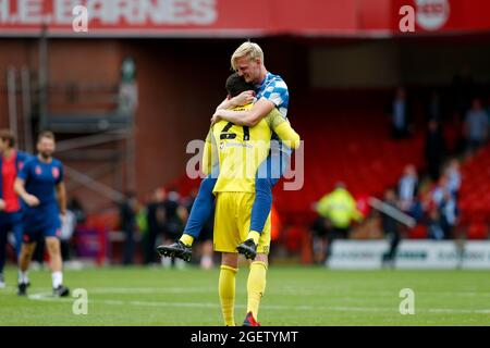 Sheffield, UK. 21st Aug, 2021. Lee Nicholls #21 of Huddersfield Town and Ryan Schofield #31 of Huddersfield Town celebrate winning the game in Sheffield, United Kingdom on 8/21/2021. (Photo by Ben Early/News Images/Sipa USA) Credit: Sipa USA/Alamy Live News Stock Photo