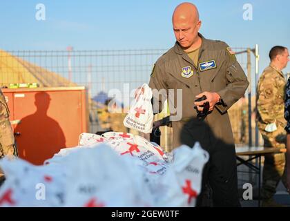 U.S. Air Force Brig. Gen. Josh Olson, 86th Airlift Wing commander, holds a comfort kit provided by the American Red Cross at Ramstein Air Base, Germany, Aug. 20, 2021. Ramstein Air Base is providing safe, temporary lodging for qualified evacuees from Afghanistan as part of Operation Allies Refuge during the next several weeks. Operation Allies Refuge is facilitating the quick, safe evacuation of U.S. citizens, Special Immigrant Visa applicants and other at-risk Afghans from Afghanistan. Qualified evacuees will receive support, such as temporary lodging, food, medical screening and treatment an