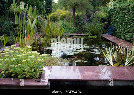 Loozen, Netherlands - August 17 2021 - An geometric pond in the pond gardens of Ada Hofman. All her ponds are on natural and ecological basis. Stock Photo