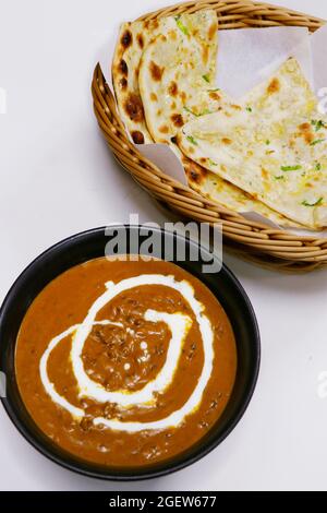 indian lentil curry known as dal makhani with tandoori naan bread Stock Photo