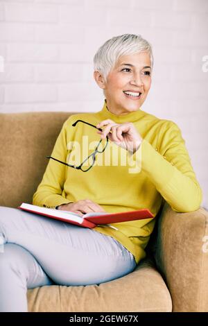 beautiful senior mature woman portrait book gray hair Stock Photo