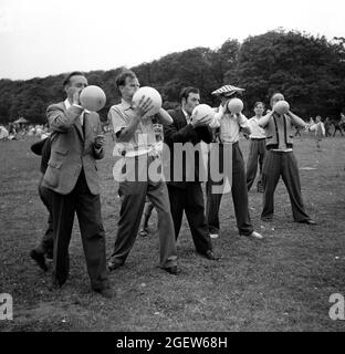 Pontins Holiday Camp family games for men blowing up balloons 1950s Britain Uk Stock Photo