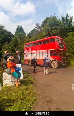 Salisbury Plain, Wiltshire, UK. 21st August 2021. Transported back to bygone days! Undeterred by the wet rainy weather lots of visitors make the most of the opportunity to discover the lost village of Imber on Salisbury Plain on a special Open Day, Imberbus event which operates many old and new Routemaster buses to take visitors to Imber and other places on the Plain.  Many braved the weather getting soaked on the top of an open top bus! This year was an Imberbus Car Free Day encouraging visitors to leave their cars behind. Credit: Carolyn Jenkins/Alamy Live News Stock Photo