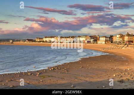 13 July 2019: Morecambe, Lancashire, UK - The beach at sunset, with a rising tide. Stock Photo