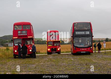 Salisbury Plain, Wiltshire, UK. 21st August 2021. Transported back to bygone days! Undeterred by the wet rainy weather lots of visitors make the most of the opportunity to discover the lost village of Imber on Salisbury Plain on a special Open Day, Imberbus event which operates many old and new Routemaster buses to take visitors to Imber and other places on the Plain.  Many braved the weather getting soaked on the top of an open top bus! This year was an Imberbus Car Free Day encouraging visitors to leave their cars behind. Credit: Carolyn Jenkins/Alamy Live News Stock Photo