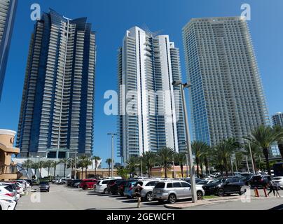 SUNNY ISLES, UNITED STATES - May 08, 2020: A view of highrise buildings from a parking lot in Sunny Isles, Florida, USA Stock Photo