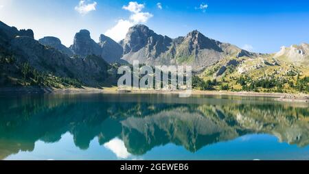 Allos lake in the morning during summer time, with mirror effect, mountains reflecting on the lake Stock Photo