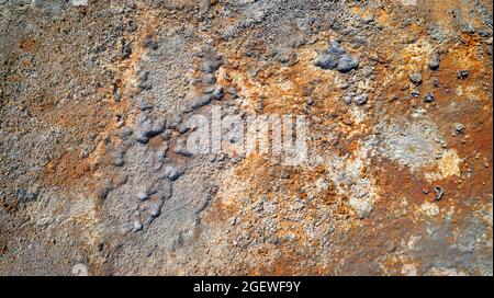 Rough wall texture in abandoned mine with spots of rust and peeling paint and plaster Stock Photo