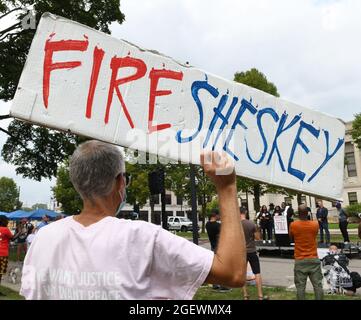 Kenosha, Wisconsin, USA. 21st Aug, 2021. BILL GREGORY holds a sign calling for the firing of police officer Rusten Sheskey at a rally in Civic Center Park in Kenosha, Wisconsin Saturday August 21, 2021 to commemorate the one-year anniversary of the shooting of Jacob Blake by Sheskey. Blake, who was shot seven times at point blank range, is paralyzed after the shooting August 23, 2020. The rally, held by the Blake family under the banner of 'Justice for Jacob,'' was at a park in front of the Kenosha County Courthouse, one of the scenes of several days of violent and fiery protests after the Stock Photo