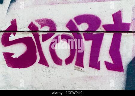 The word Sport written on a wood background in cool street-art graffiti style representing youth and lifestyle Stock Photo