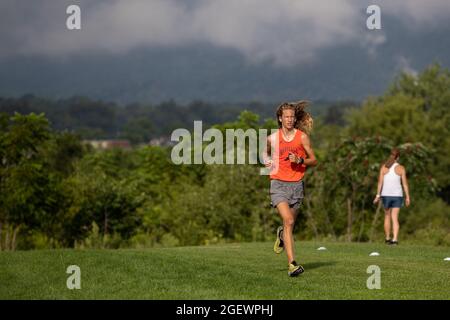 Danville, United States. 21st Aug, 2021. A member of the Danville High School cross country team is seen running during the 9th Annual Danville Cross Country 5K Community Run/Walk.The event, which benefits the Danville Area High School girls and boys cross country teams, resumed after being canceled in 2020 due to the COVID-19 pandemic. Credit: SOPA Images Limited/Alamy Live News Stock Photo