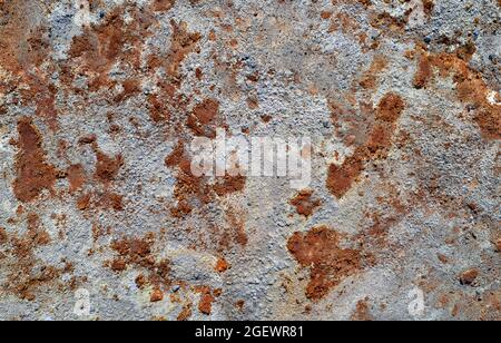 Grey stone texture with spots of rust, abandoned industrial background Stock Photo