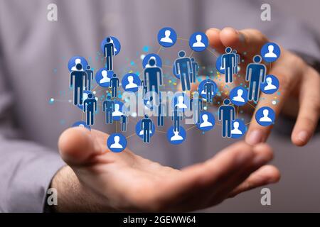 3D rendered people silhouettes held in a person's hand Stock Photo - Alamy