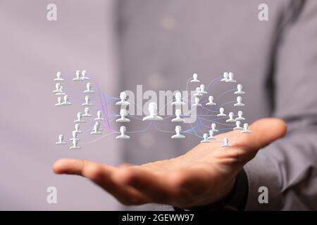 3D rendered people silhouettes held in a person's hand Stock Photo - Alamy