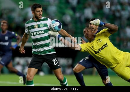 Lisbon, Portugal. 21st Aug, 2021. Paulinho of Sporting CP (L) vies with Belenenses SAD's goalkeeper Luiz Felipe during the Portuguese League football match between Sporting CP and Belenenses SAD at Jose Alvalade stadium in Lisbon, Portugal on August 21, 2021. (Credit Image: © Pedro Fiuza/ZUMA Press Wire) Stock Photo