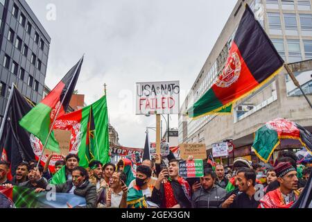 London, UK. 21st Aug, 2021. Protesters march with flags and placards during the demonstration in Oxford Street. Demonstrators marched through Central London in protest against the Taliban takeover of Afghanistan, and called on the UK Government to impose sanctions on Pakistan and to help the people of Afghanistan. Credit: SOPA Images Limited/Alamy Live News Stock Photo