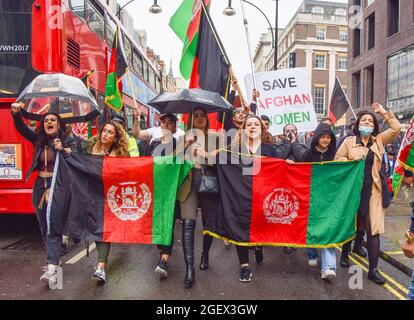 London, UK. 21st Aug, 2021. Protesters march with flags and placards during the demonstration on Oxford Street. Demonstrators marched through Central London in protest against the Taliban takeover of Afghanistan, and called on the UK Government to impose sanctions on Pakistan and to help the people of Afghanistan. Credit: SOPA Images Limited/Alamy Live News Stock Photo