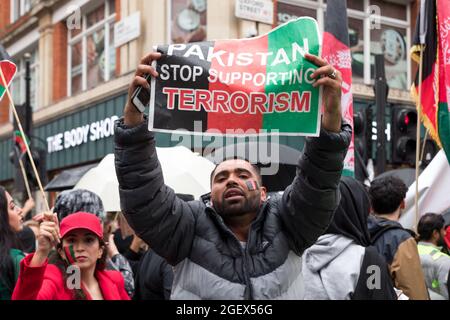 A protestor seen holding a sign that says Pakistan stop supporting terrorism during the demonstration.Following the recent seizure of Afghanistan's capital Kabul by the Taliban, activist groups, including Stop the War UK and Afghan interpreters/ translators in London gathered outside Parliament Square to express solidarity with Afghans. They were calling for urgent action by the Boris Johnson government to protect family members whose lives are under threat, specifically shedding light on female and children's rights. (Photo by Belinda Jiao/SOPA Images/Sipa USA) Stock Photo