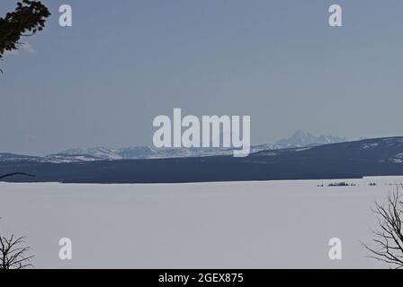 Looking across a large frozen lake at high mountains in the backgroundYellowstone Lake and Teton Mountains as seen from Lake Butte Overlook ; Date:  24 April 2013 Stock Photo