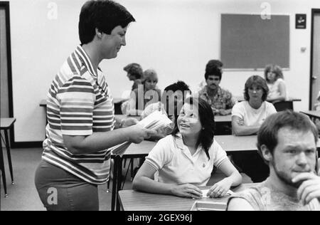 San Marcos Texas USA, circa 1993: Proctor hands out paperwork to  Southwest Texas State University students taking a pre-professional standardized aptitude exam in classroom  MR EP-0010  ©Bob Daemmrich Stock Photo
