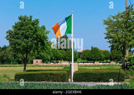 The Irish flag flying proudly over the memorial to Irish poet Francis Ledwidge (1887-1917), buried at Artillery Wood Cemetery (background photo) Stock Photo