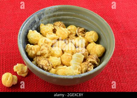 Taiwanese bubble tea caramel popcorn in bowl on red background Stock Photo
