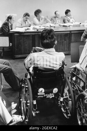 Austin Texas USA, circa 1990: Handicapped citizens in wheelchairs attend meeting of city transportation board to advocate for accessibility. Stock Photo