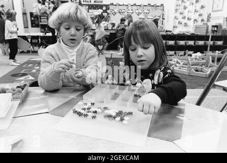 Austin Texas USA, 1994: Kindergarten children practice math skills by sorting objects in class. ©Bob Daemmrich Stock Photo