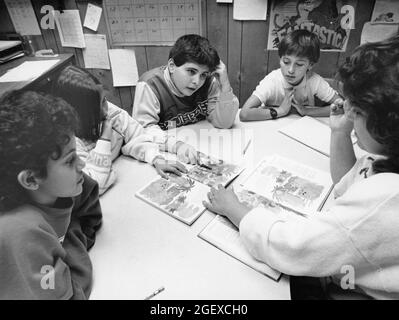 Austin Texas USA, circa 1992: Elementary school teacher working with English as a Second Language (ESL) students in public elementary school classroom. ©Bob Daemmrich Stock Photo