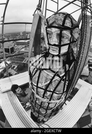 Austin, Texas USA, circa 1984: Worker secures a harness around the Goddess of Liberty statue atop the dome of the Texas Capitol building before crews remove the statue for restoration work. ©Bob Daemmrich Stock Photo