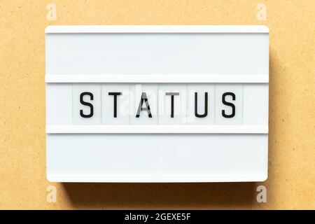 Lightbox with word status on wood background Stock Photo