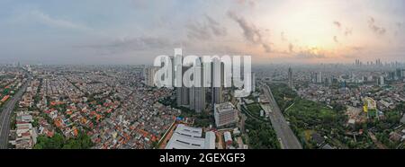 Aerial view of 'Taman Anggrek' the biggest shopping mall and apartment in Jakarta when sunrise. Jakarta, Indonesia, August 22, 2021 Stock Photo