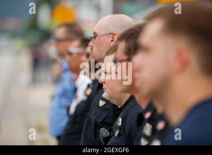 SPENCER, INDIANA - AUGEST 18: Firefighters line W. Morgan Street during the funeral procession for fallen paramedic Brandon Staley passes on August 18, 2021 in Spencer, Indiana. Staley died from a heart attack while working as a paramedic for Owen County EMS. Staley had just responded to a vehicle accident and was in an ambulance with crash survivors helping them on the way to a hospital when he himself became ill. Stock Photo